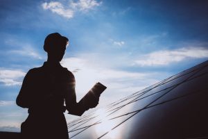 Man-worker-firld-by-solar-panels